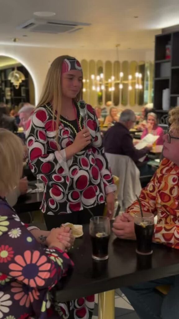 Guest in a 1970s outfit at Sanam Tandoori's Shish Mahal Night in Falkirk